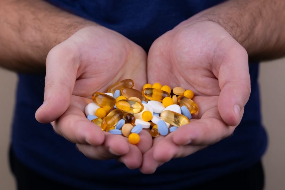 person holding medicine pills