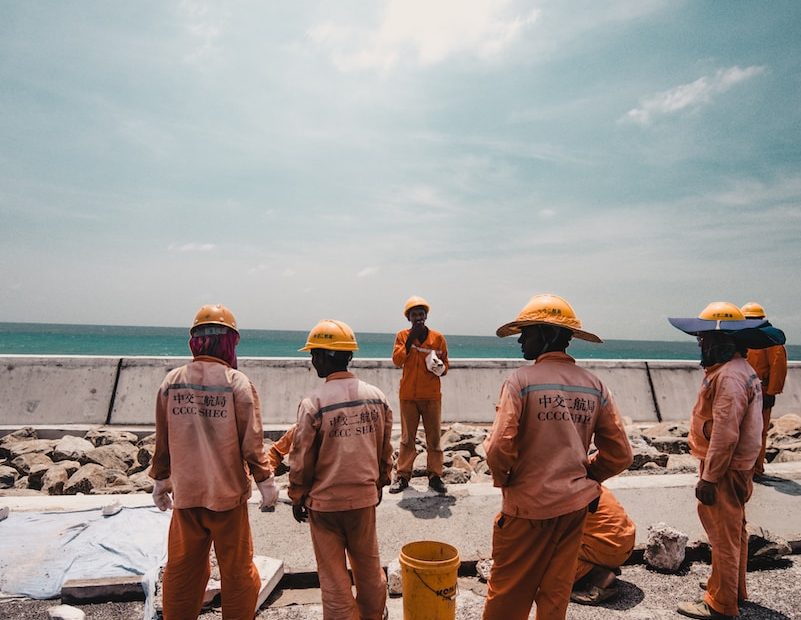 five person working road during daytime