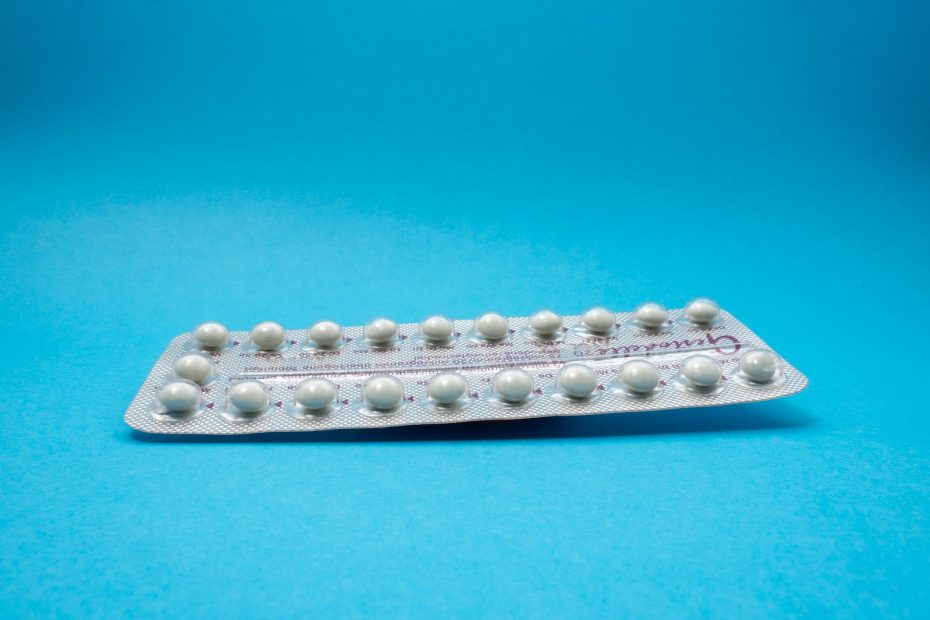 oral contraceptive pill on blue panel