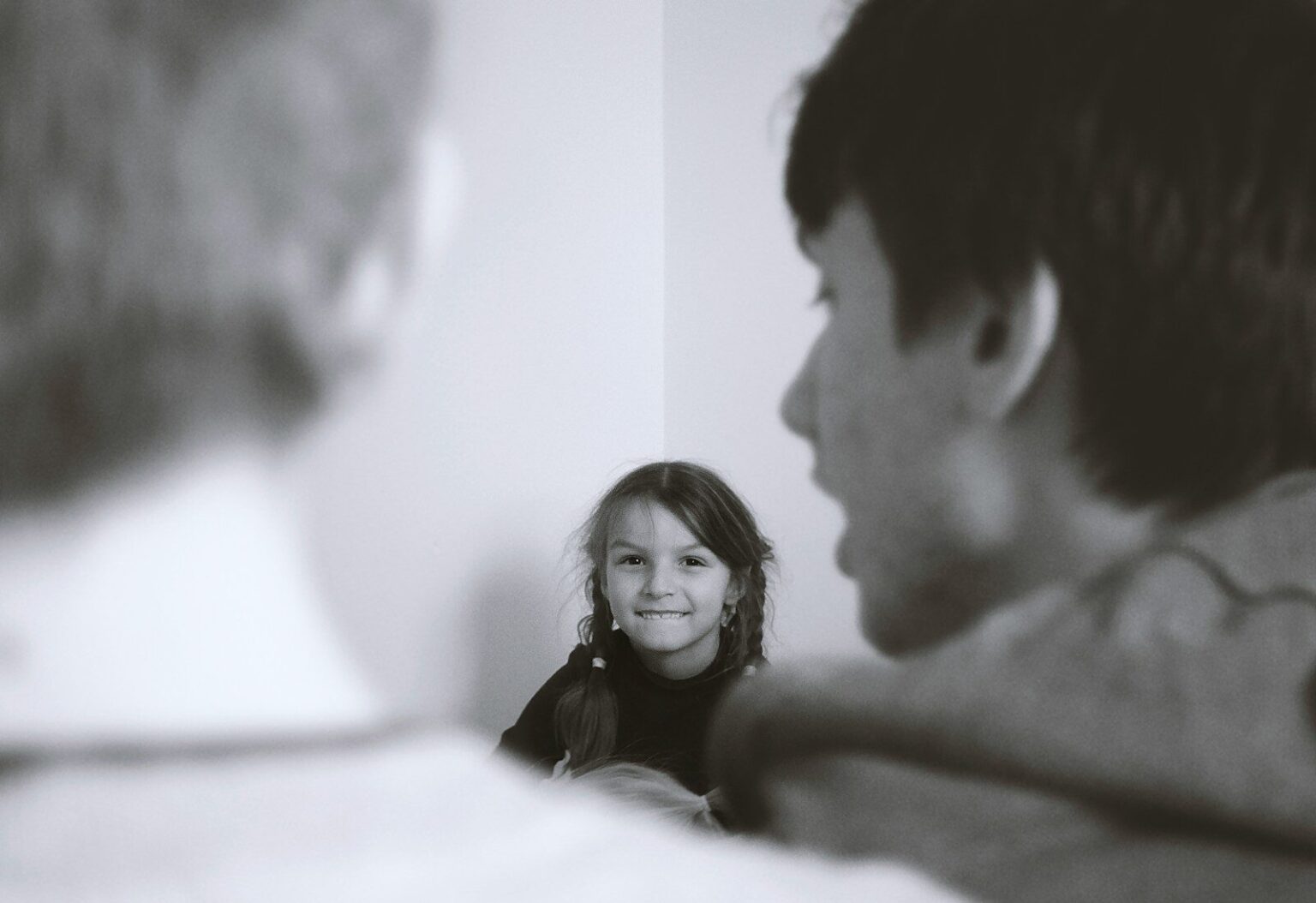 man and woman smiling in grayscale photography