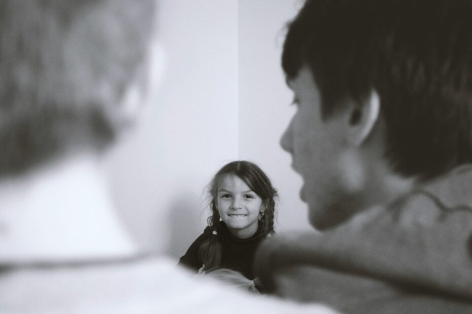 man and woman smiling in grayscale photography
