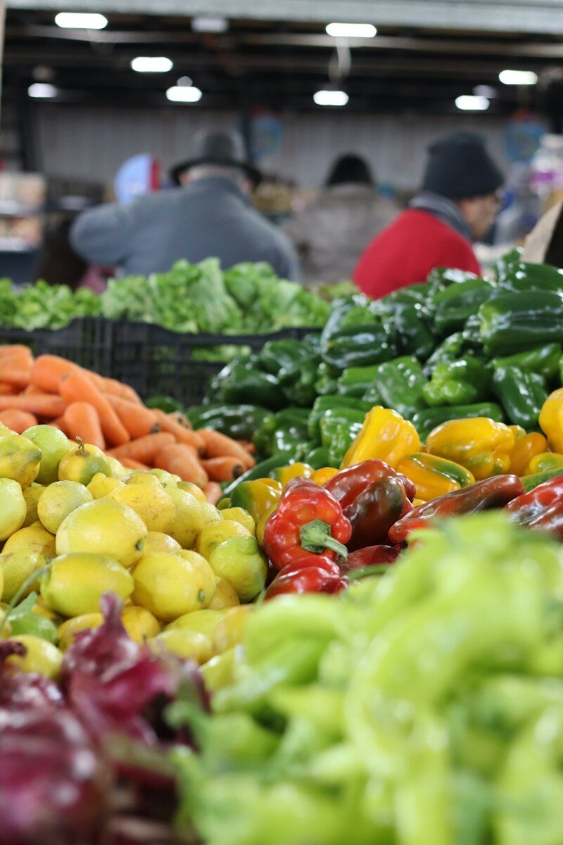 Fresh produce is displayed at a lively farmer's market